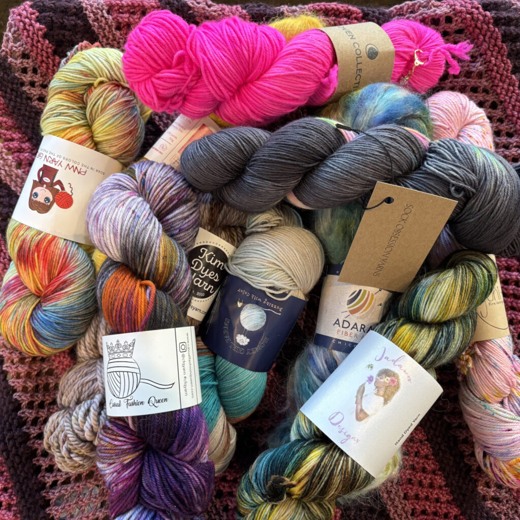 hanks of colorful hand-dyed yarn on a table